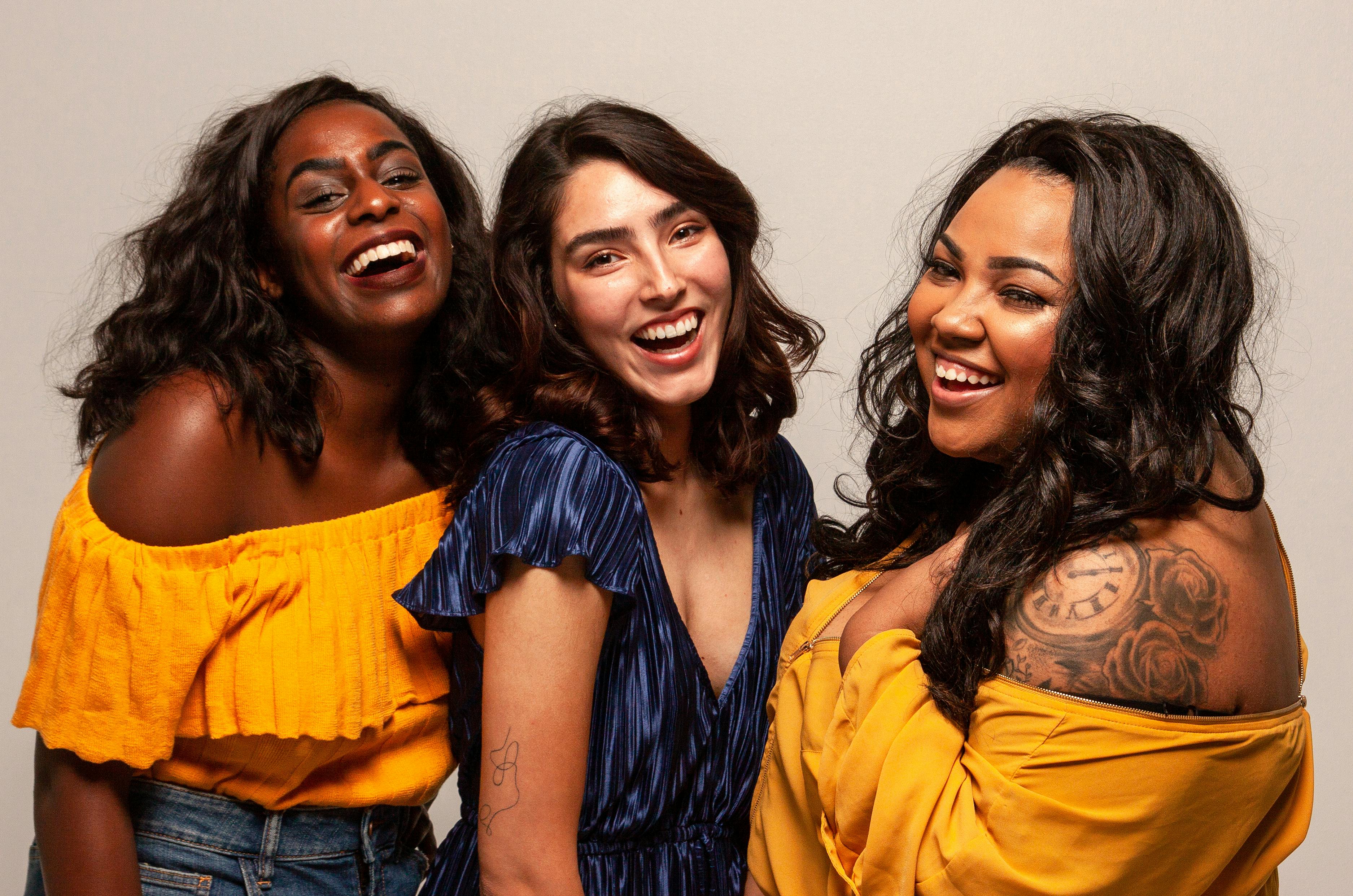 3 young women smiling after learning about pre-pregnancy nutrition